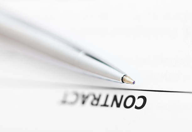 istock contract and tip of silver pen 534868847