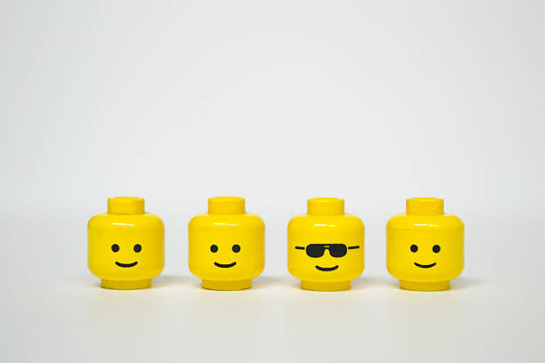 Lego mini figure heads Florence, Italy - January 15, 2015: Lego mini figure heads are looking at the camera. Different head wearing glasses. everyday item stock pictures, royalty-free photos & images