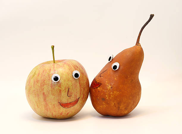 istock pair of fruits apple and PEAR with eyes 534870593