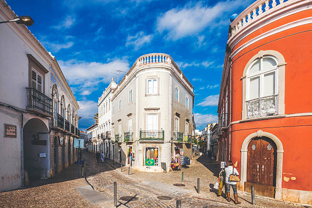 Tavira, Portugal - December 24, 2014: A few people walking around the streets of old town on a sunny afternoon.