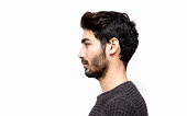 Profile view of serious young man over white background