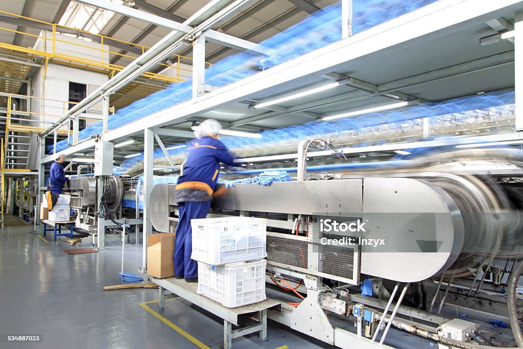 Workers in the PVC gloves production lines Luannan County, March 6:  Workers in the PVC gloves production lines in a factory on March 6, 2012, in Luannan County, Hebei Province, China Production Line Stock Photo