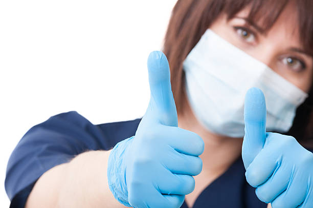 Dentist woman holding thumbs-up stock photo