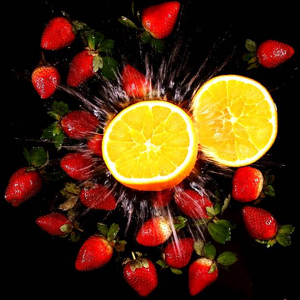 istock splashing water - Strawberries and cut Orange 534888727