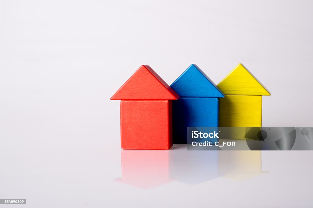 City  by little bricks Urban scene in children wooden building blocks. Focused on the front blocks. Concept shot that can be used for house building, house shopping, ownership, investment, mortgage etc. Isolated on white background and  reflection. Block Shape Stock Photo