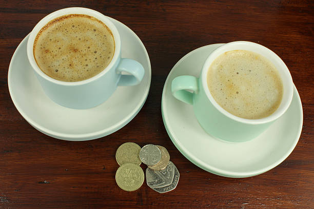 English Currency with two coffee cups. stock photo