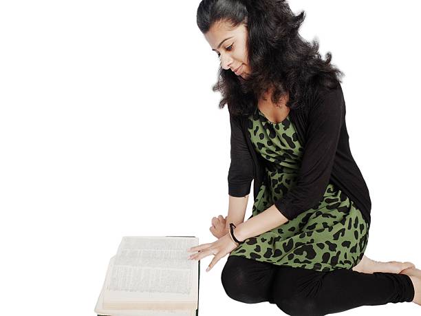 istock Pretty Indian student sitting with books over white. 534891469