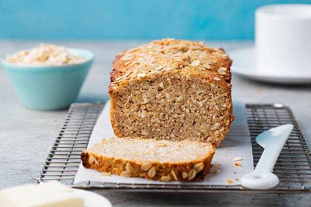 Healthy vegan oat, coconut loaf bread, cake on cooling rack stock photo