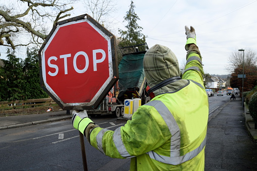Worker holding stop traffic sign