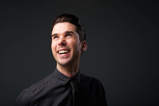 istock Happy young man in black shirt and tie 534894009