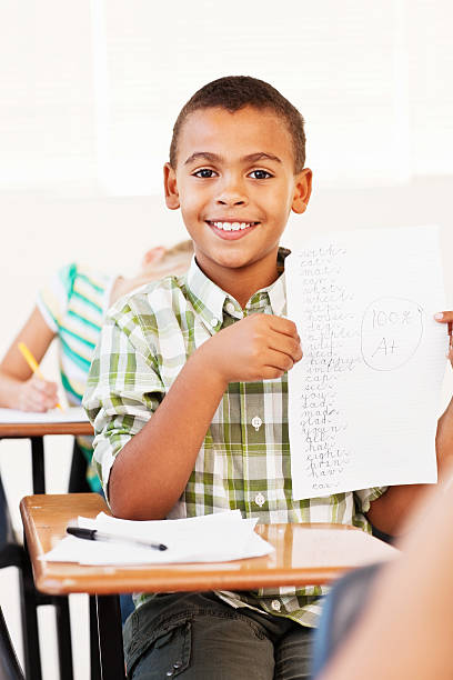 istock Adorable school boy with his exam answer paper 534894103