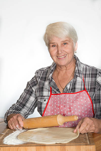 istock senior woman making cookies 534894137