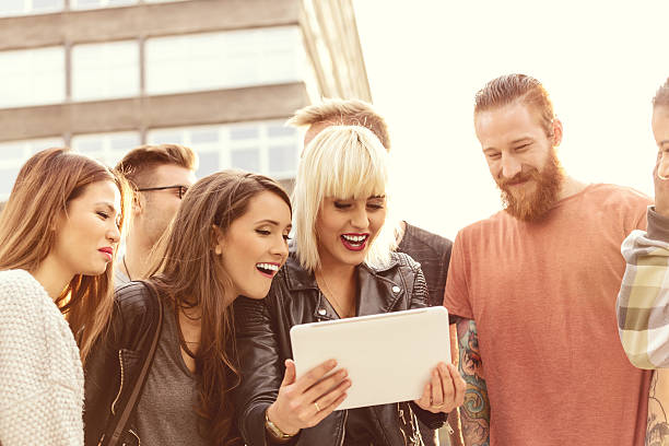 istock Group of friends using digital tablet outdoor 534894795