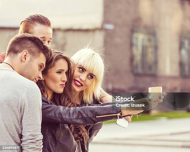 Friends Taking Selfie At Sunset Stock Photo - Download Image Now - 2015, Adult, Blond Hair