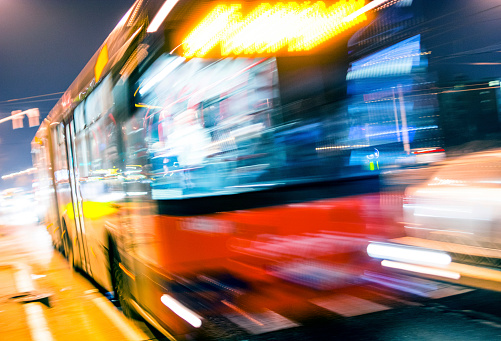 Bus driving on city street, motion blur. Long exposure.