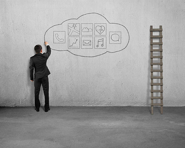 istock Businessman standing and drawing app icon on concrete wall 534895797
