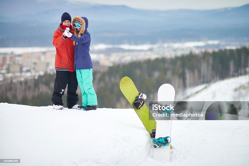 Selfie on snow hill Young couple of snowboarders taking selfie on snowy hill 2015 Stock Photo