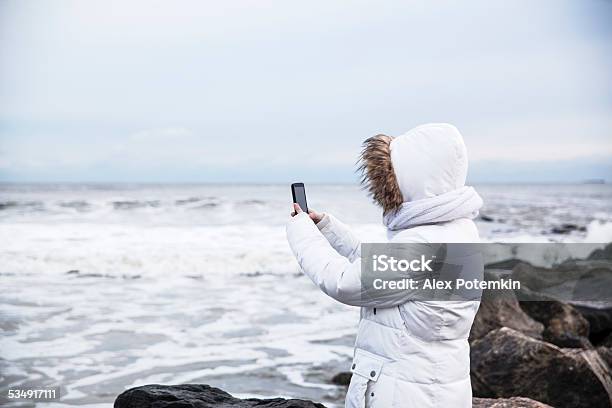 Teenager Girl Make A Picture With Smartphone Stock Photo - Download Image Now - 2015, Adolescence, Beach