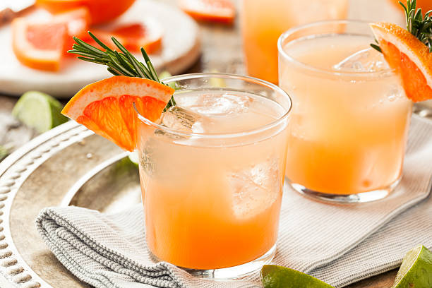 Refreshing Grapefruit and Tequila Palomas Refreshing Grapefruit and Tequila Palomas with Rosemary tequila drink stock pictures, royalty-free photos & images