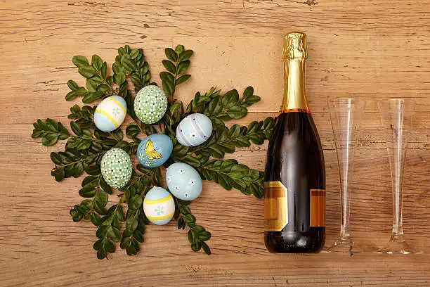 Easter decoration, champagner bootle and champagne glasses on wood