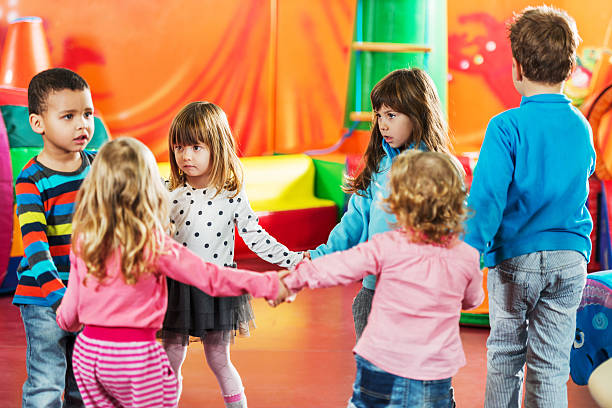 istock Group of children dancing in a circle. 534918993