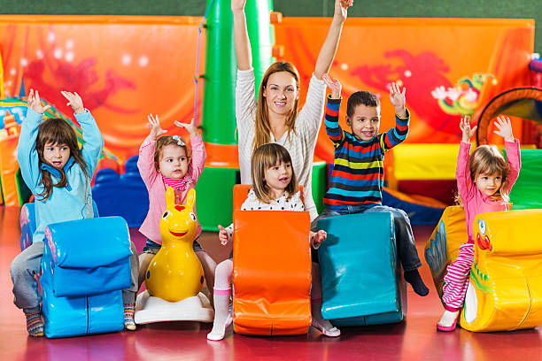 istock Playful children with teacher in a playroom. 534919019