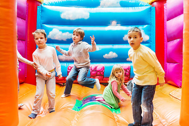 istock Children enjoying in bouncy castle. 534919067