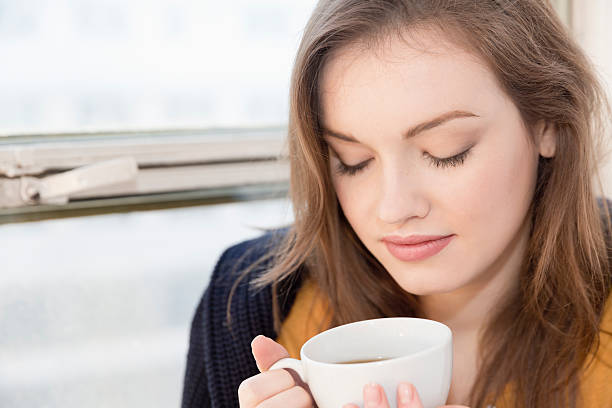 istock Young woman holding a cup of coffee 534919241