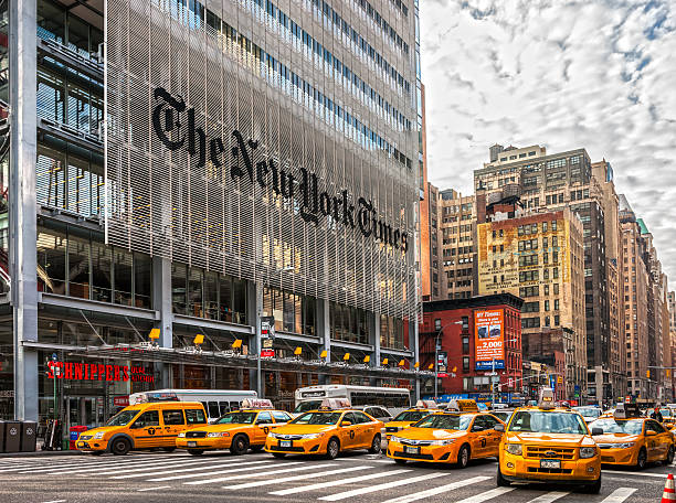 NEW YORK CITY New York city, USA - December 01, 2013: The New York Times building and characteristic NYC Yellow Taxi Cab, waiting the street light turns to green. 42nd street photos stock pictures, royalty-free photos & images