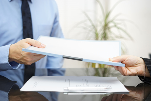 Man and woman are exchanging contract or document