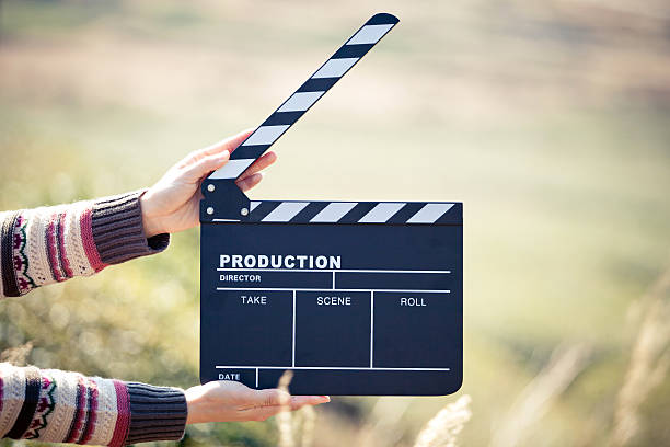 Hands holding a movie clapboard