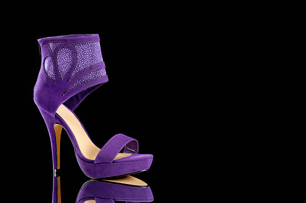 Women's Purple Pump Shoe on black background stock photo