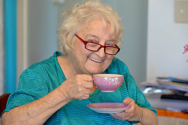 istock One happy old lady, reading glasses and cup of tea 534922663