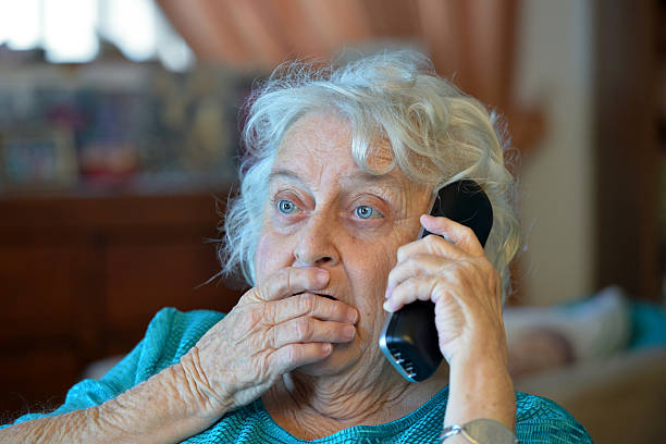 istock One old lady on the phone looking shocked 534922687