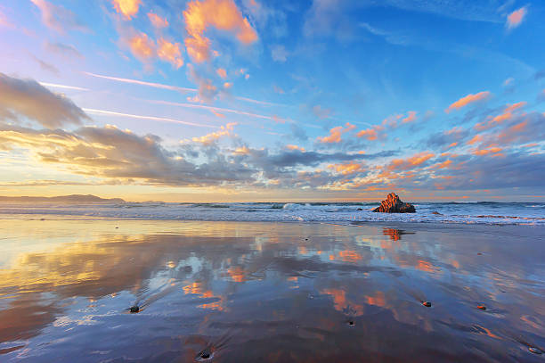 Sopelana beach at sunset with couds reflections Sopelana beach at sunset with couds reflections on shore sopelana stock pictures, royalty-free photos & images