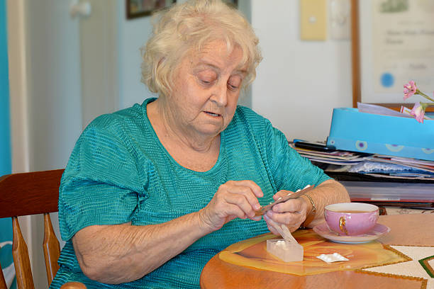 istock One sad old lady counting out her weekly pills 534923923