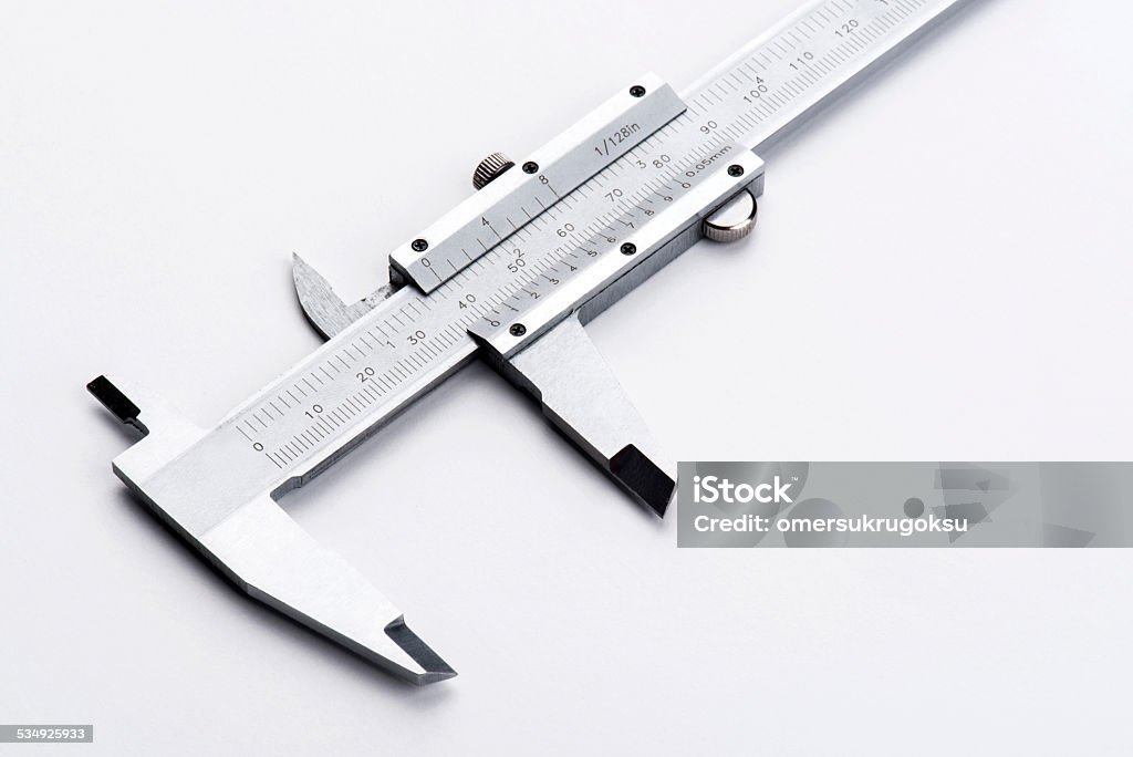 Vernier Caliper Caliper lying on white surface. Caliper Stock Photo