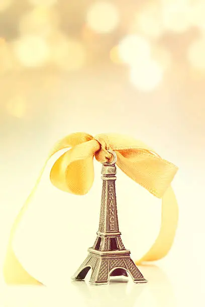 Miniature Eiffel-tower with defocused spot lights in background.
