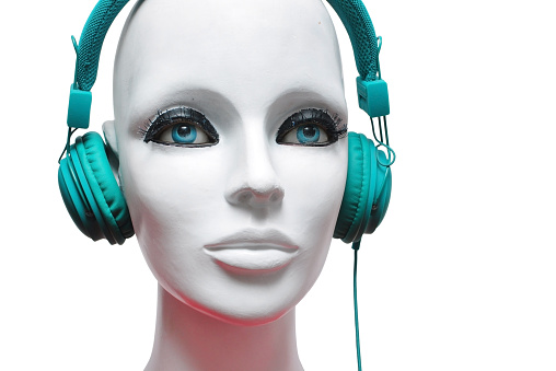 white face with blue eyes mannequin and audio headphones