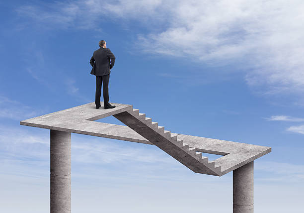 Businessman and Impossible Staircase Rear view of businessman standing and looking on the impossible staircase with cloudy sky background. He is looking further, thinking and searching new ideas. Digitally generated image inspired Escher's impossible stairs. chimera stock pictures, royalty-free photos & images