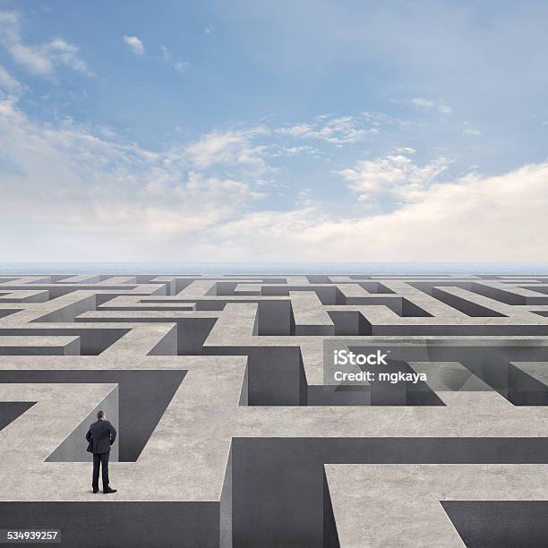 Businessman On The Labyrinth Wall Stock Photo - Download Image Now - Maze, Concrete, Horizon