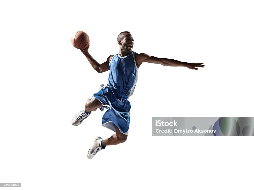 Isolated basketball player Close up image of isolated professional basketball player about to do slam dunk Basketball Player Stock Photo