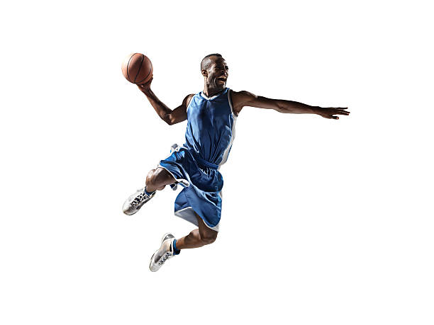 Isolated basketball player Close up image of isolated professional basketball player about to do slam dunk athletes stock pictures, royalty-free photos & images