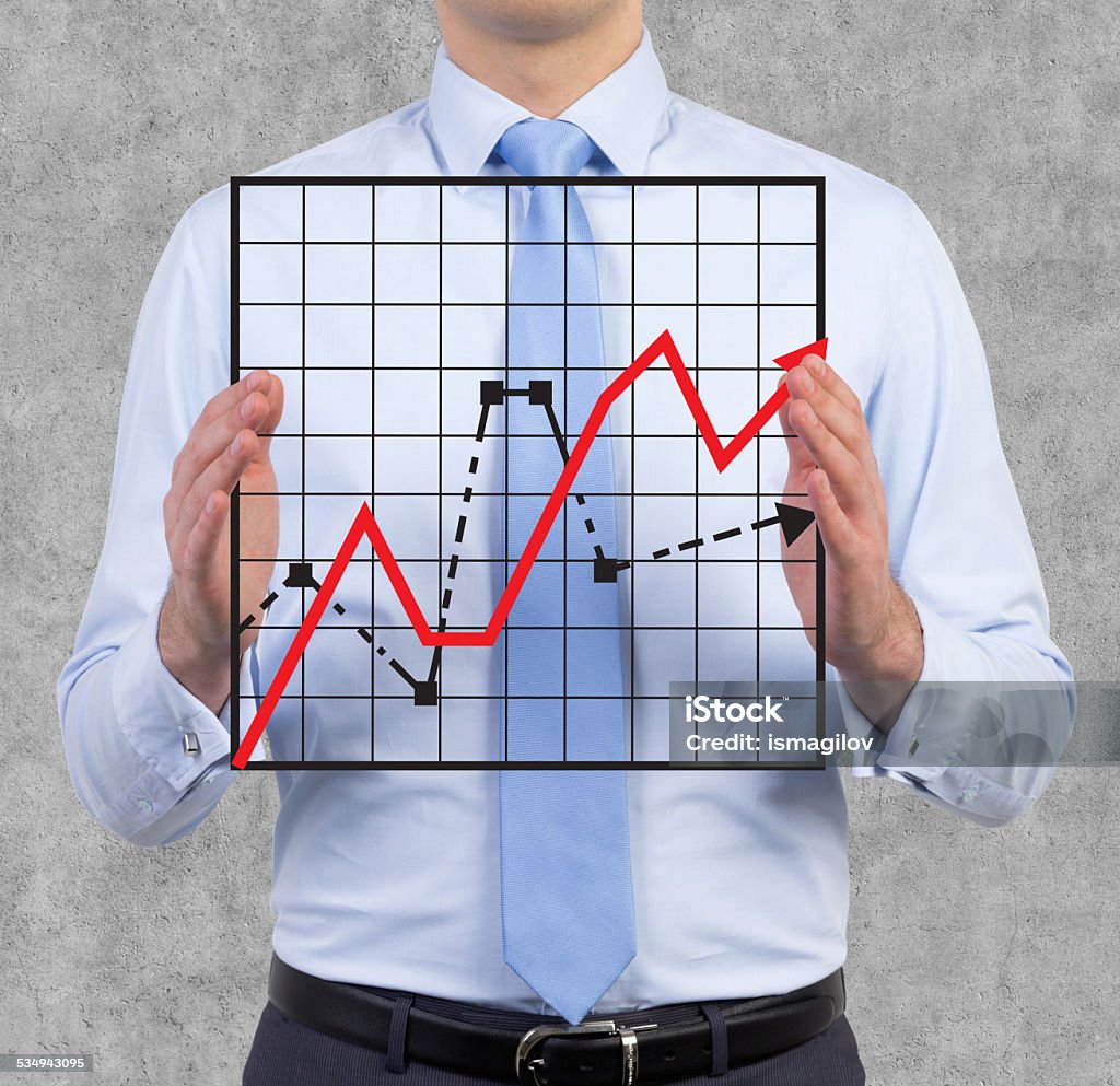 businessman holding graph businessman holding graph and arrow in hand 2015 Stock Photo