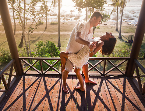 couple resting at Balinese hotel, dancing on the balcony