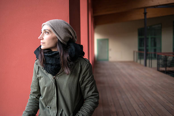 istock Woman looking out from balcony in winter 534943719