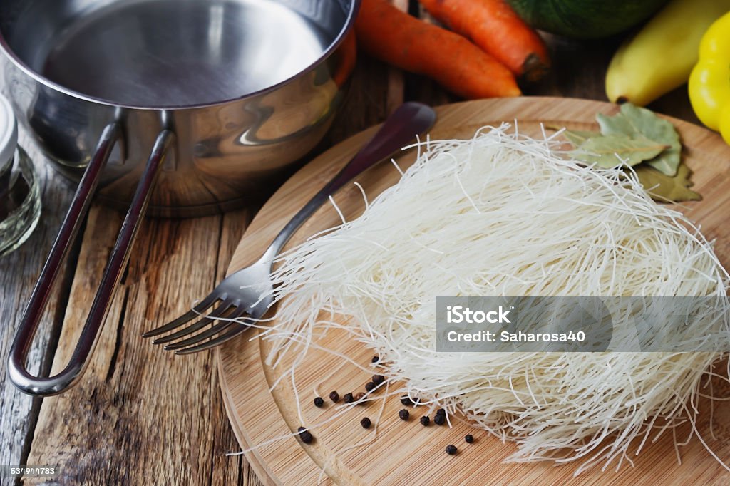 rice pasta rice pasta on a cutting board on the old wooden background. health and diet food. traditional oriental cuisine 2015 Stock Photo