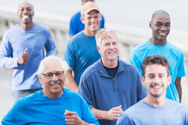 istock Multiracial group of men in blue shirts running 534971801