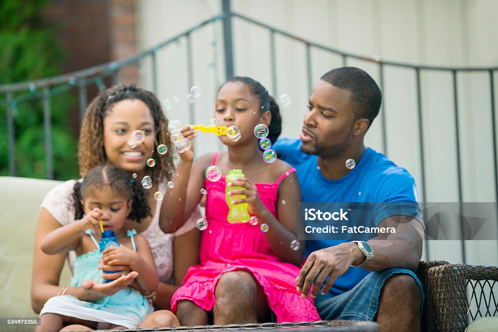 Backyard family Happy family having fun at backyard Adult Stock Photo