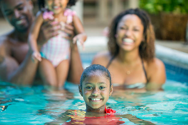 Swimming Family having fun in their pool. scuba diving family stock pictures, royalty-free photos & images